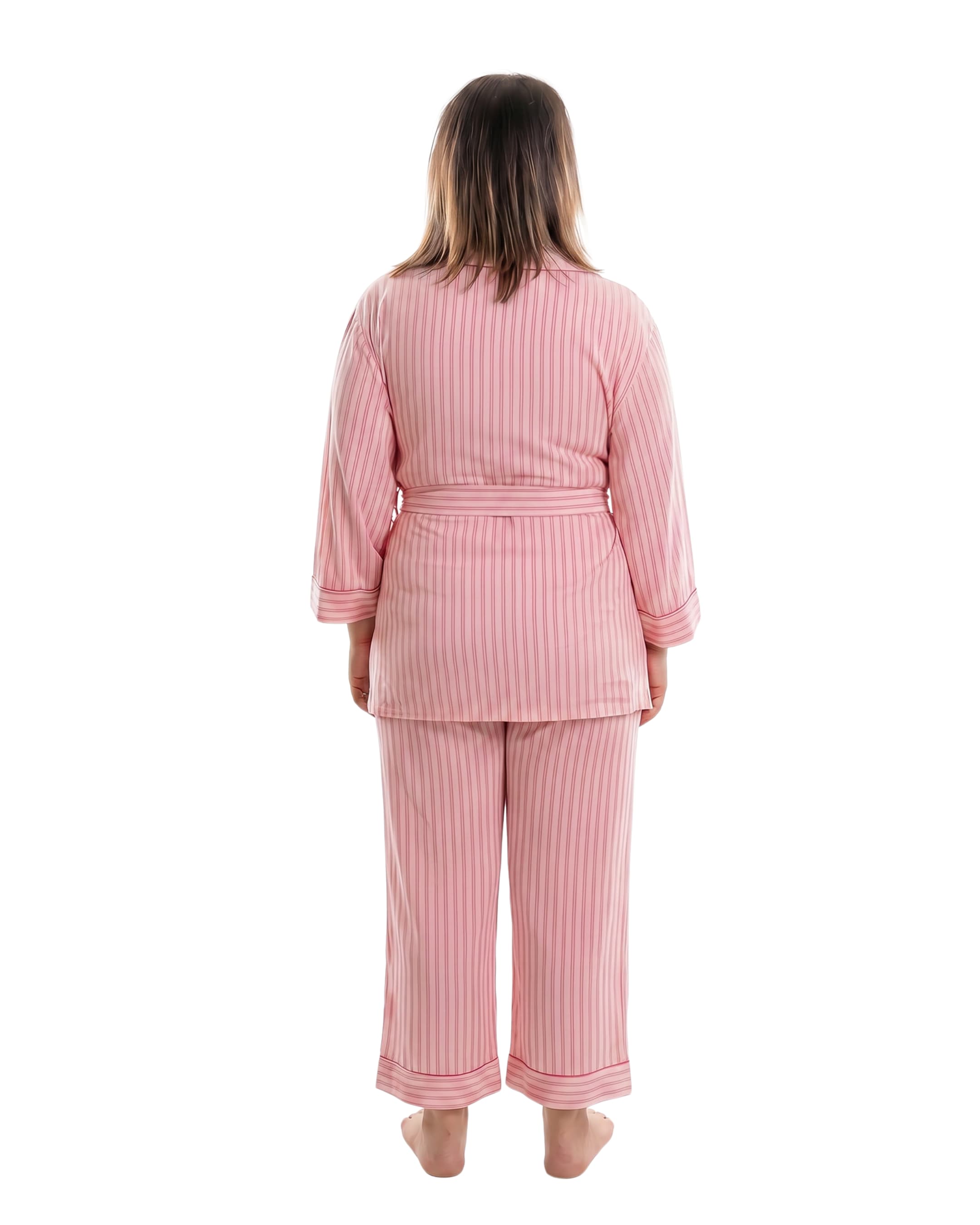 A woman viewed from the back wearing a pink vertically striped pajama set with a sash tie top and matching pants, standing against a plain white background.