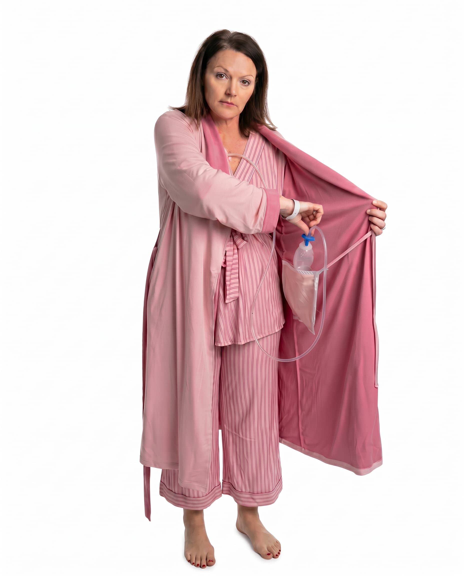 Woman wearing a pink recovery robe with an surgical bag going into the internal pocket on a white background