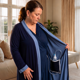 navy recovery robe highlighting the interior drain pocket with tubing against a modern bedroom background