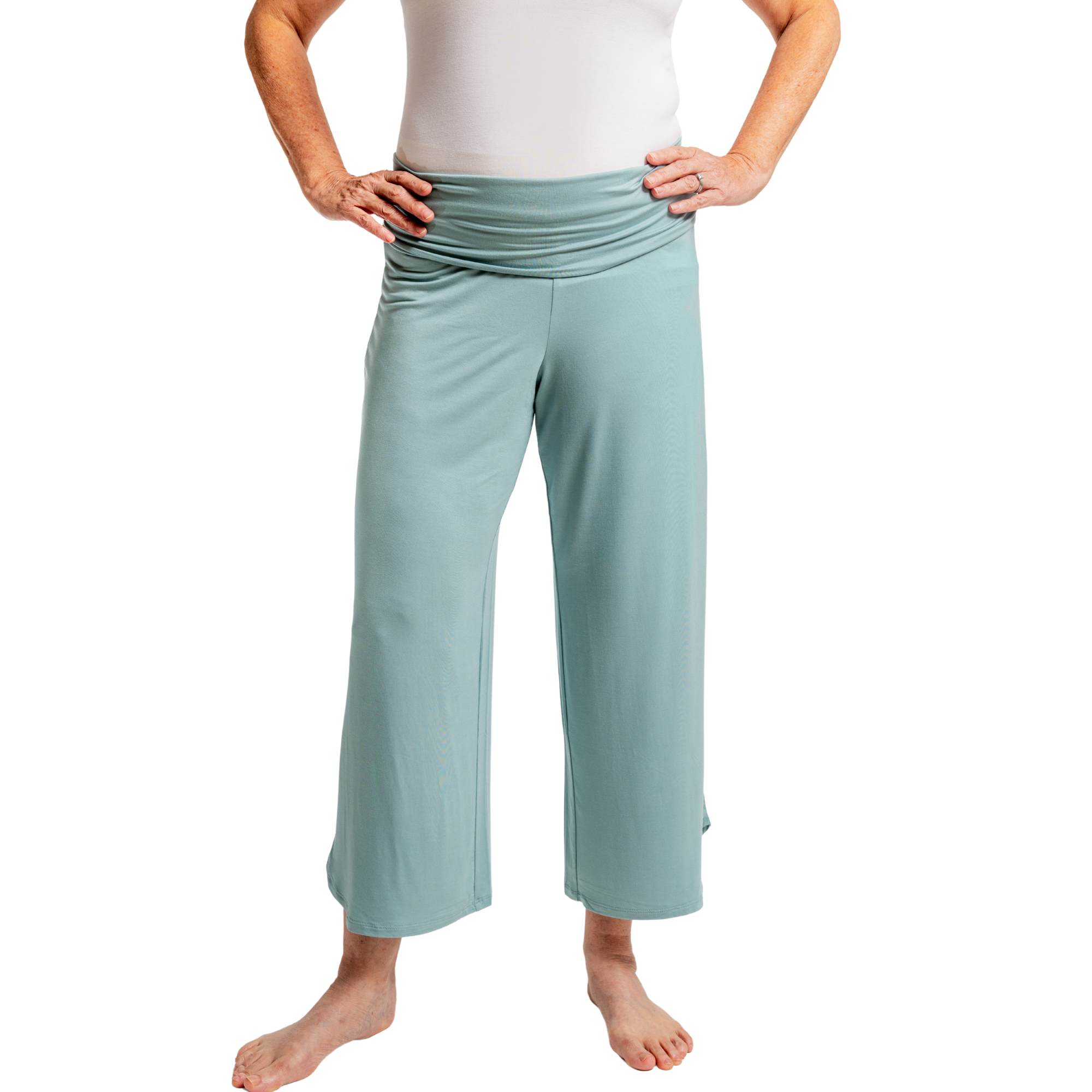 Pink pants worn by a person on a white background showcasing low-rise waistband