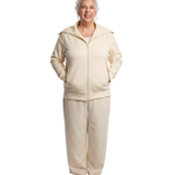 front side shot of woman in a cream recovery loungewear set with her hands in her pockets, which feature a scallop detail