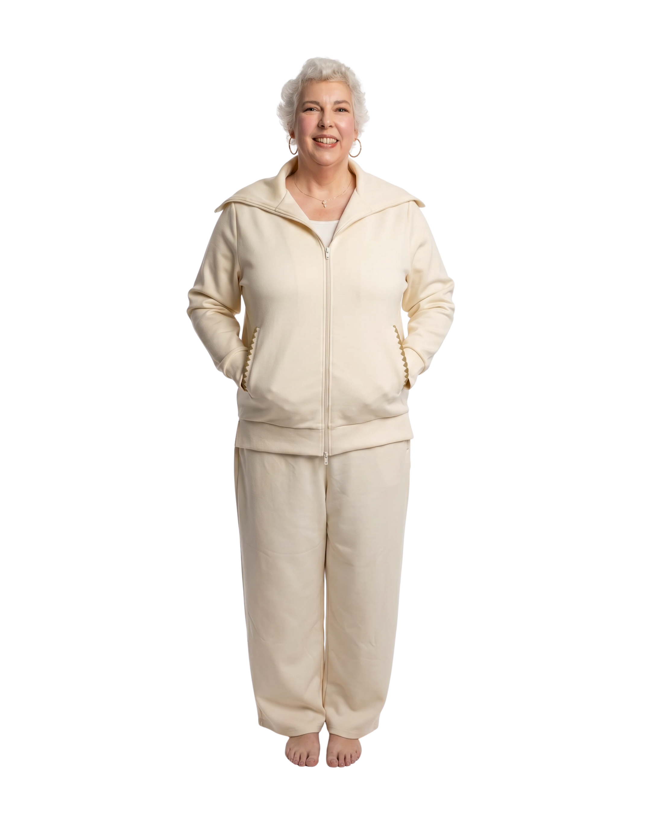 front side shot of woman in a cream recovery loungewear set with her hands in her pockets, which feature a scallop detail