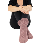 Rose Slipper Socks on Woman wearing Black pants against a white background