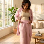 woman recovering from surgery in a pink post surgery pajamas set showing the adaptive pants that have a fold-over waistband