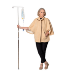 Woman in a beige cape holding an IV pole on a white background