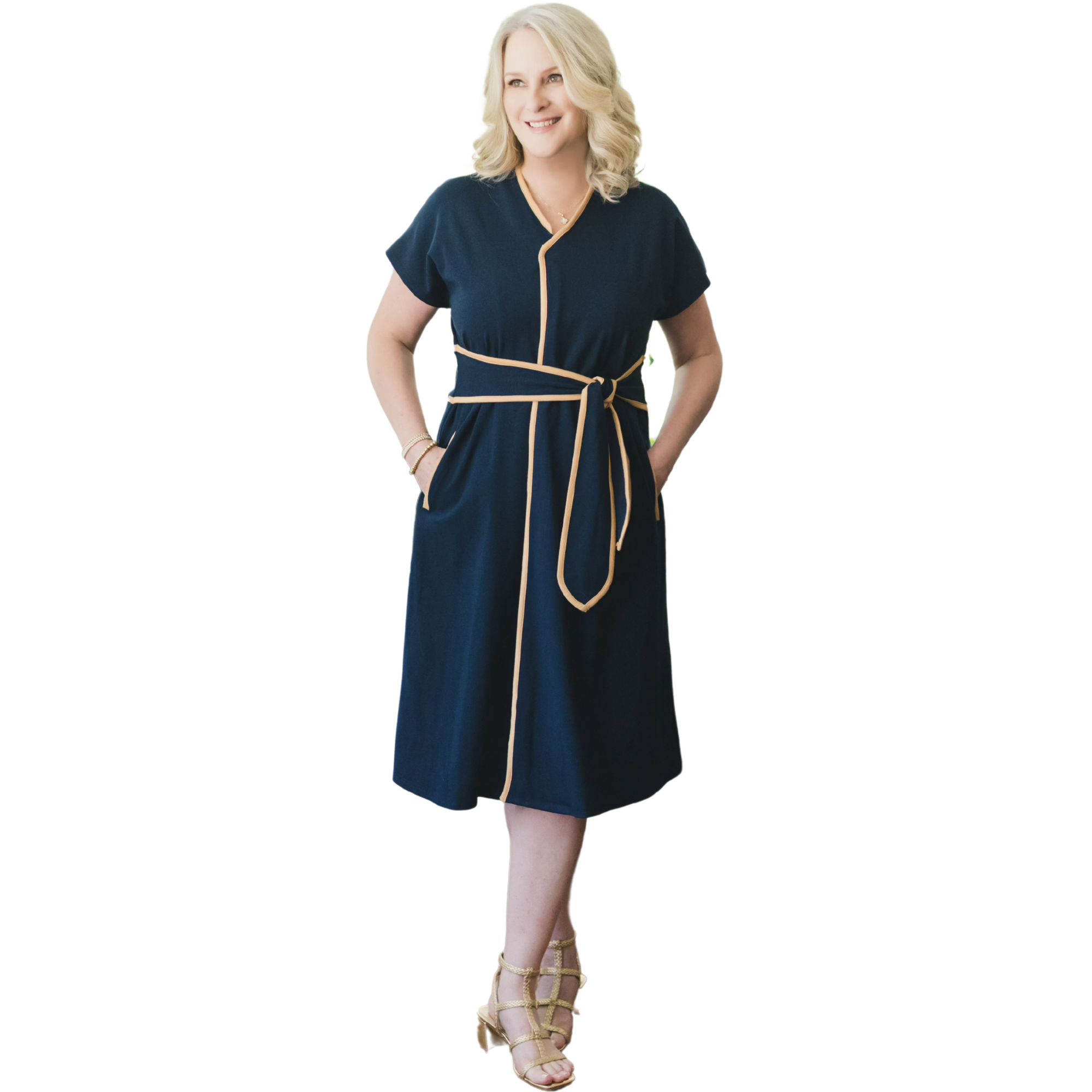 Woman wearing a  zip up front navy dress with a belt on a white background