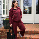 woman in red recovery set as she leaves her house with her drain pockets secured
