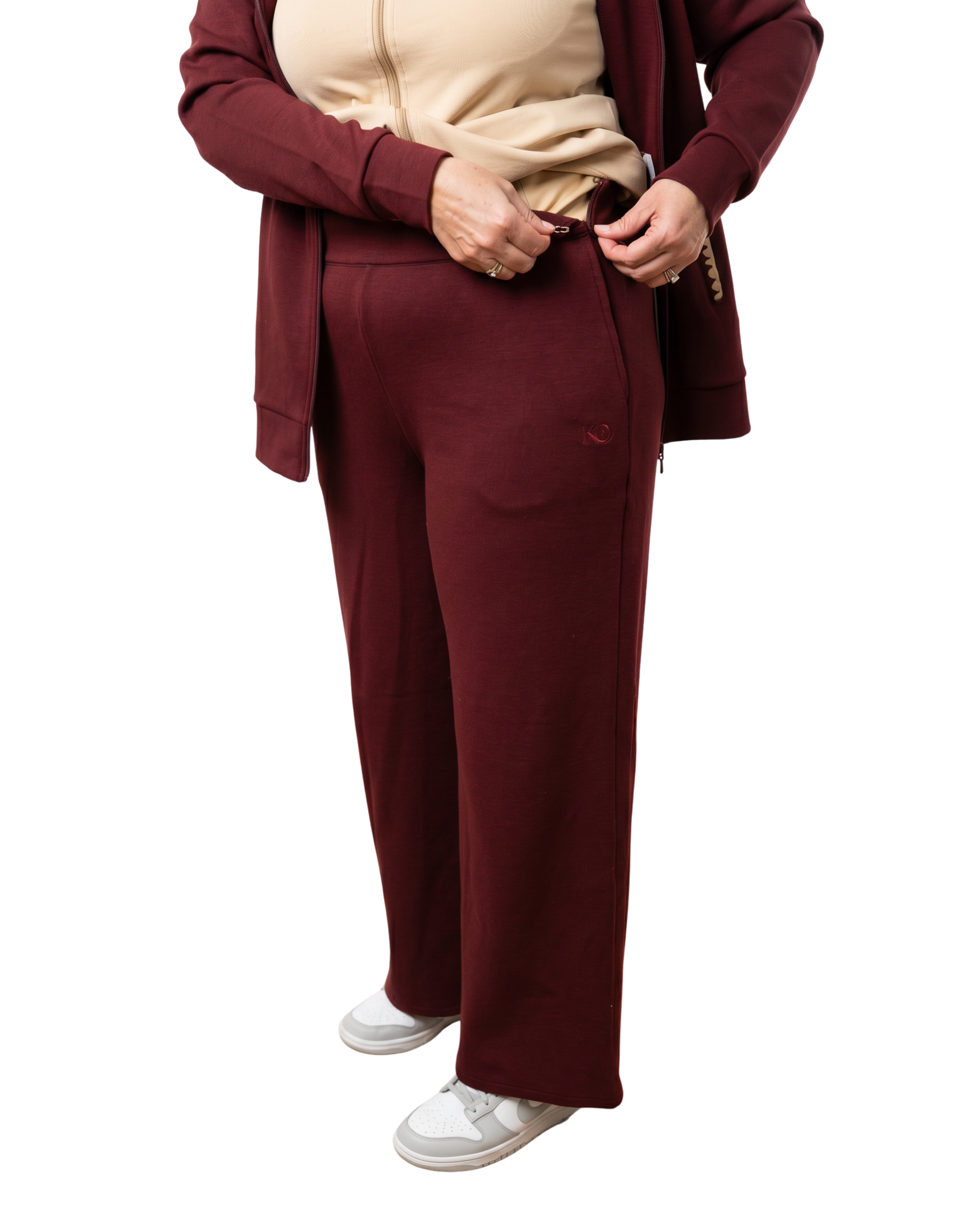 Woman in mulberry red recovery set pants showcasing the side closure