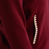 Close-up of a mulberry recovery set with a decorative scalloped cream detail on the pocket