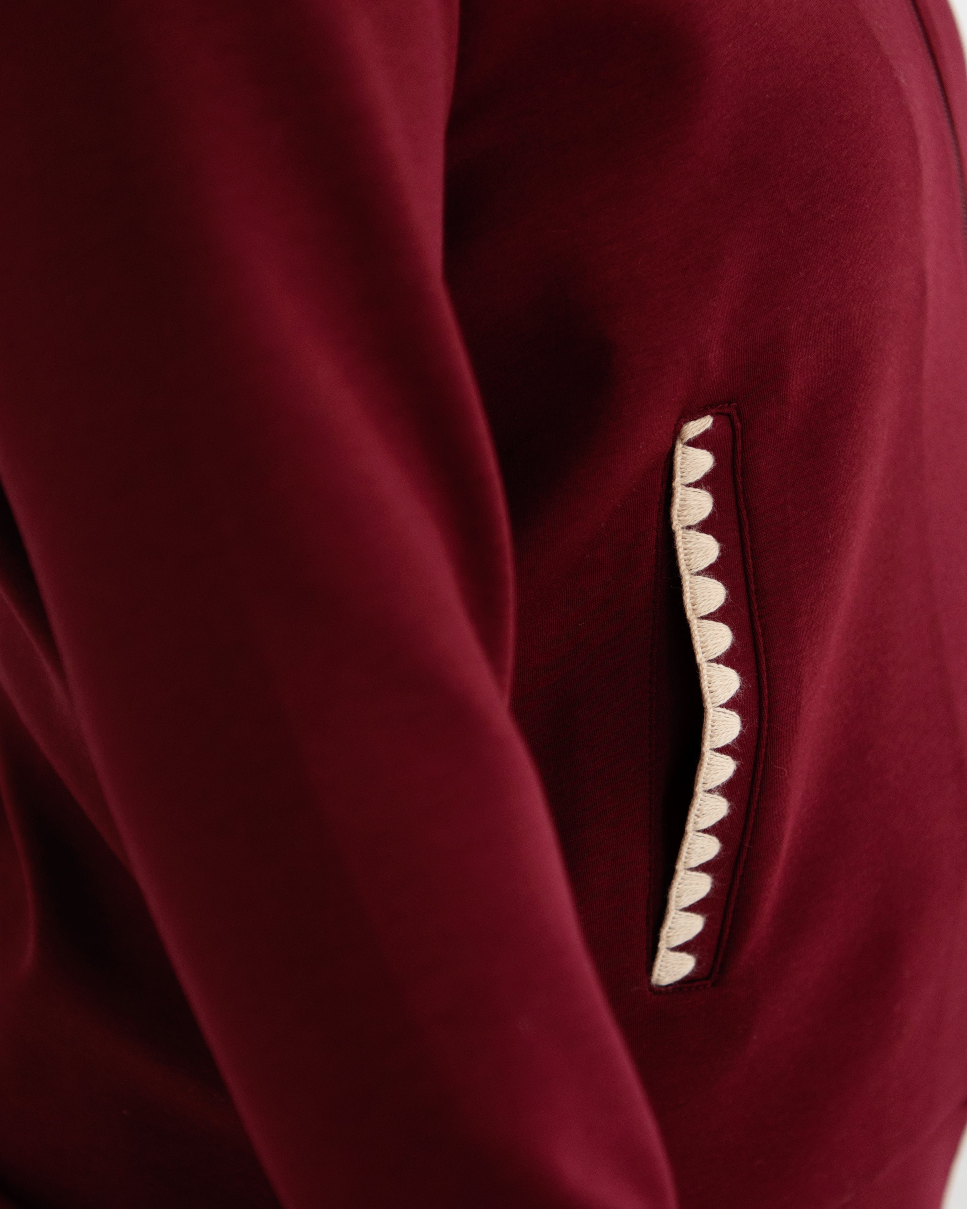 Close-up of a mulberry recovery set with a decorative scalloped cream detail on the pocket