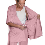 woman wearing pink mastectomy pajamas showing the inside drain pocket and the inside tie functionality