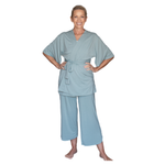 Woman wearing a short sleeve sage robe and pants set on a white background