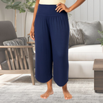 Person wearing navy blue comfy pants in a living room setting
