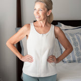 Woman wearing a white sleeveless top with zipper front for easy on and off during limited mobility after surgery