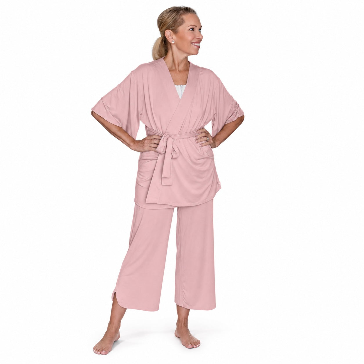 woman wearing a pink recovery pajamas set against a white background
