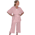 woman wearing a pink recovery pajamas set against a white background
